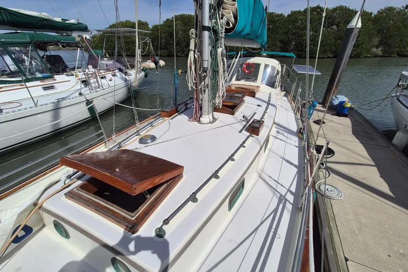 Pearl Yacht Photos Pics Sailboat docked, Cape George 36, 1996 model, with wooden deck details and green canopy.