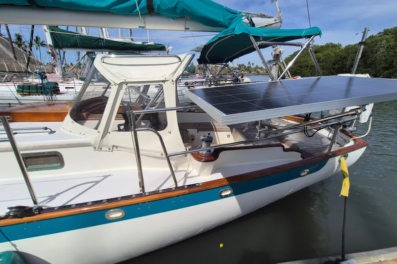 Pearl Yacht Photos Pics Cape George 36 sailboat, 1996 model, with solar panels docked in a marina.