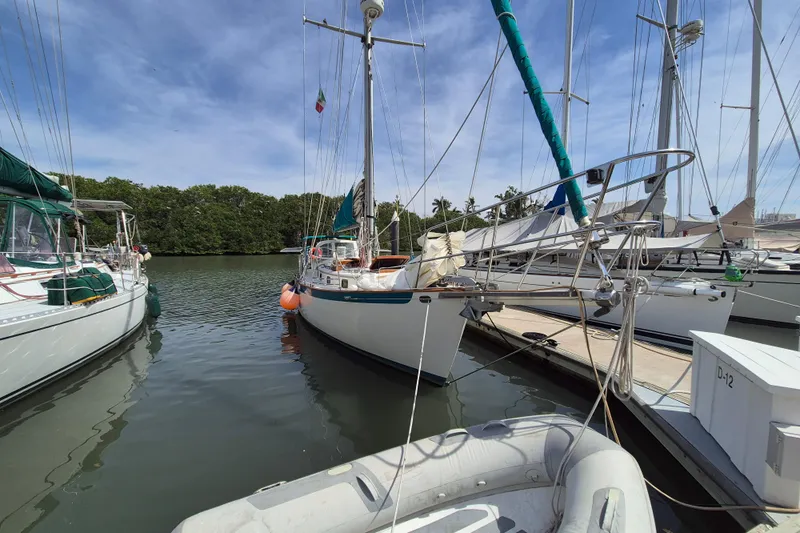 Pearl Yacht Photos Pics 1996 Cape George 36 sailboat docked in a marina, surrounded by other boats.