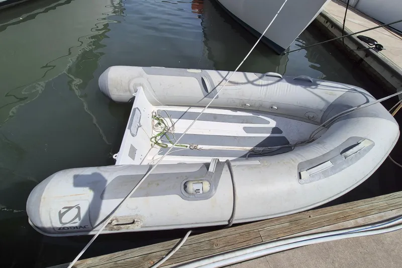 Pearl Yacht Photos Pics Inflatable Zodiac boat docked beside a Cape George 36, 1996 model.