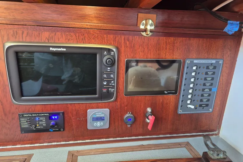 Pearl Yacht Photos Pics Control panel of a 1996 Cape George 36 sailboat with navigation and electrical systems.