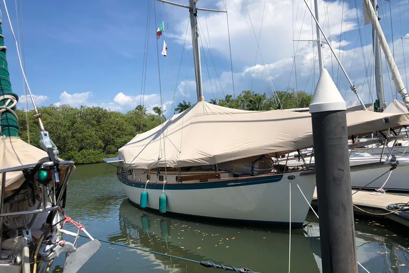 Pearl Yacht Photos Pics Sailboat docked, covered, Cape George 36, 1996 model, in a serene marina setting.