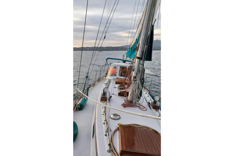 Pearl Yacht Photos Pics Sailing on a 1996 Cape George 36 yacht, serene ocean view, overcast sky.