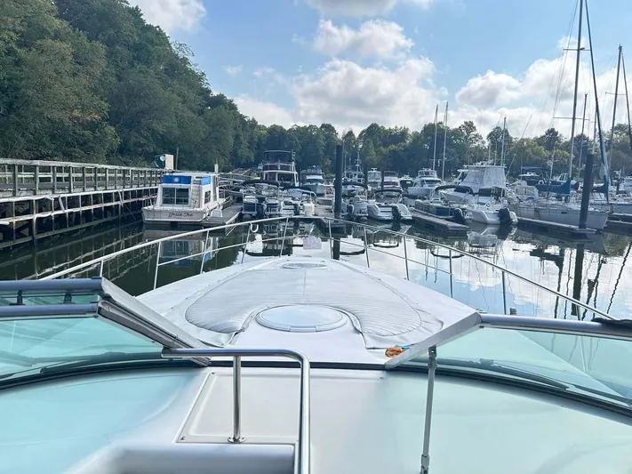 Intrepid Yacht Photos Pics 1997 Cruisers Yachts 4270 Esprit docked in a serene marina with surrounding boats.
