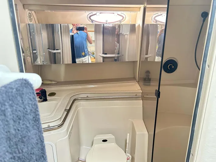 Intrepid Yacht Photos Pics Bathroom interior of 1997 Cruisers Yachts 4270 Esprit with mirrored cabinets and shower.