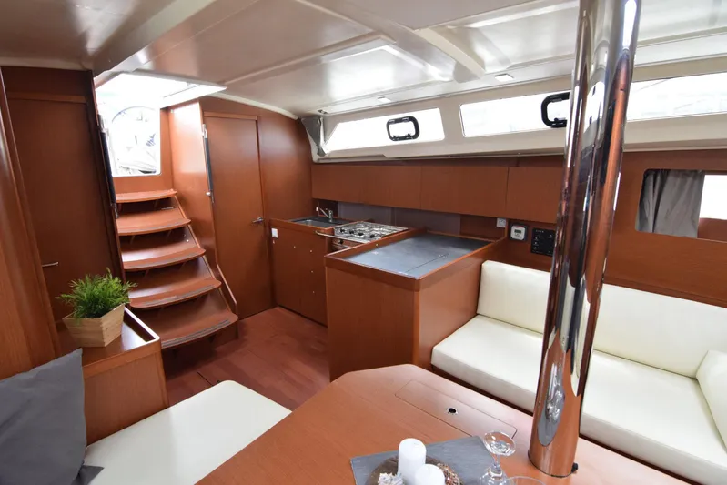  Yacht Photos Pics Interior of 2017 Beneteau Oceanis 41.1 yacht with modern wood finish and cozy seating.