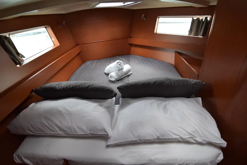  Yacht Photos Pics Cozy cabin interior of 2017 Beneteau Oceanis 41.1 yacht with neatly arranged bedding.