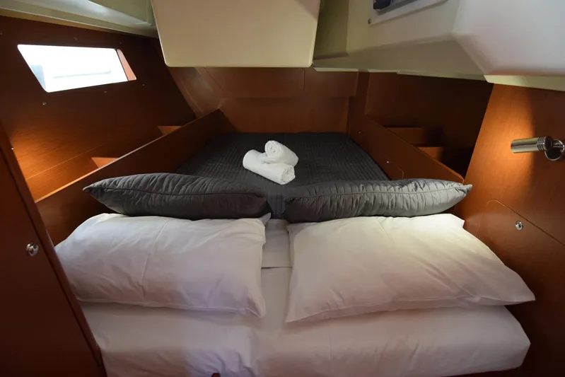  Yacht Photos Pics Cozy cabin interior of 2017 Beneteau Oceanis 41.1 yacht with neatly arranged bedding.
