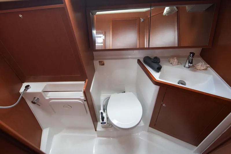  Yacht Photos Pics 2017 Beneteau Oceanis 41.1 yacht bathroom with modern fixtures and wooden cabinetry.