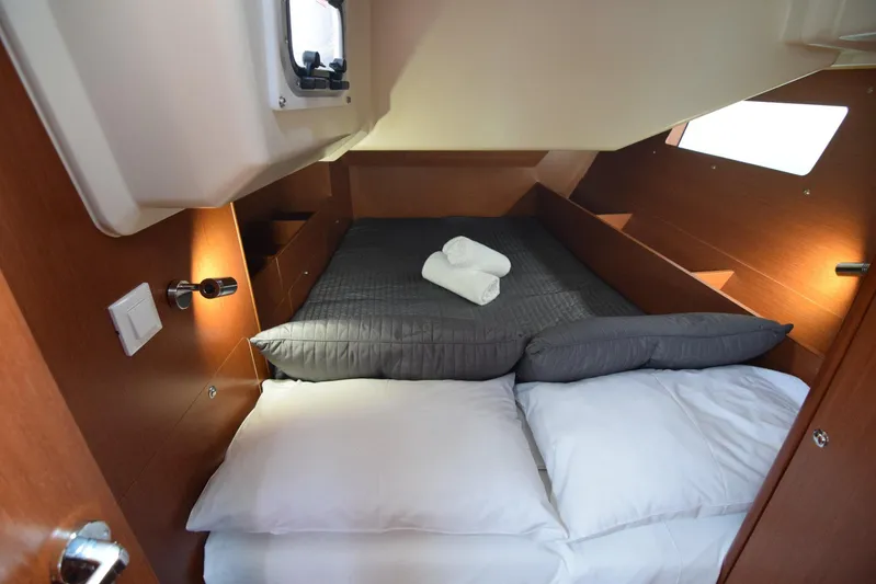  Yacht Photos Pics Cozy cabin interior of 2017 Beneteau Oceanis 41.1 yacht with neatly arranged bedding.