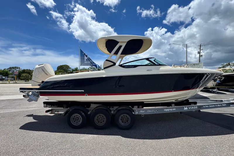  Yacht Photos Pics 2026 Chris-Craft Sportster 28 boat on trailer under a partly cloudy sky.