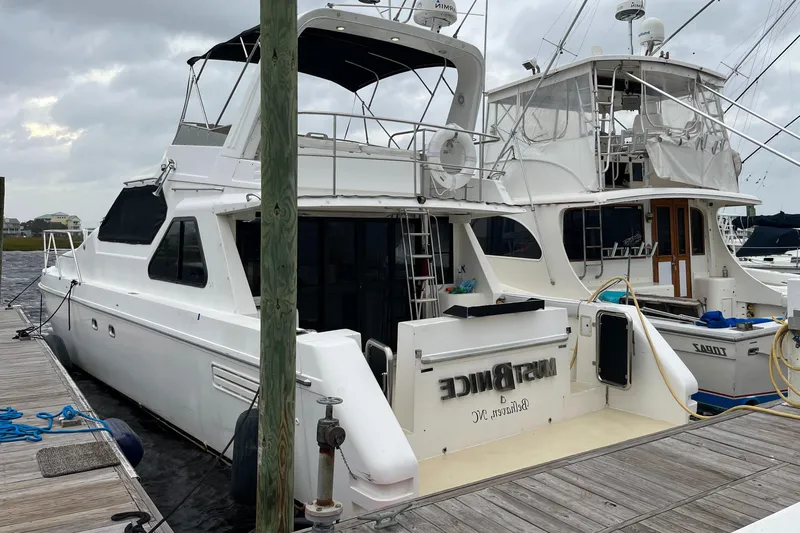 Must B Nice Yacht Photos Pics Custom Sports Catamaran 44, 2001 model, docked at marina on a cloudy day.