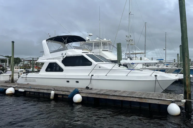 Must B Nice Yacht Photos Pics Custom Sports Catamaran 44, 2001 model, docked at marina under cloudy skies.