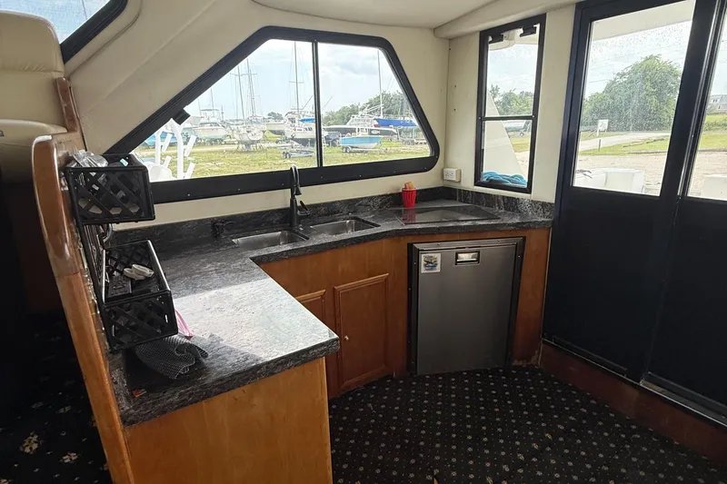 Must B Nice Yacht Photos Pics Interior of 2001 Custom Sports Catamaran 44 with kitchenette, sink, and window view.