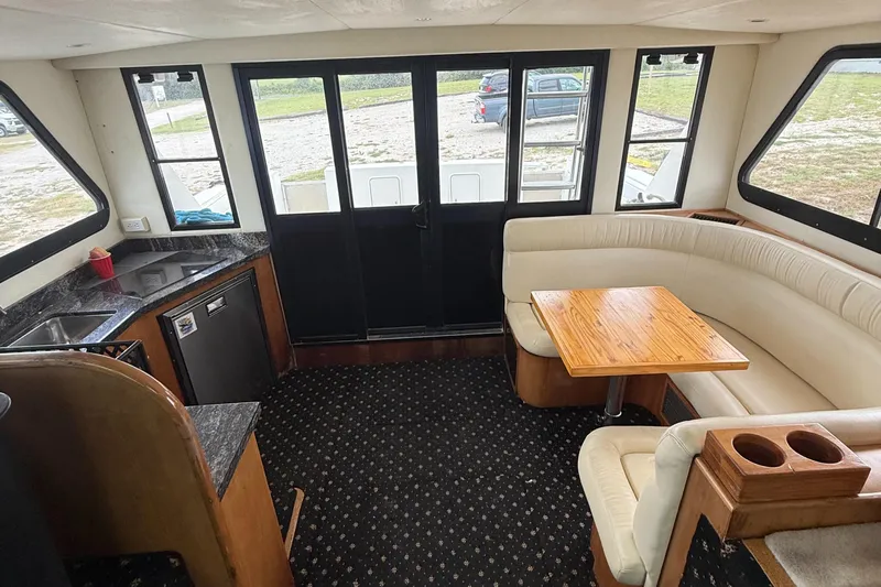 Must B Nice Yacht Photos Pics Interior of 2001 Custom Sports Catamaran 44 with kitchen and seating area.