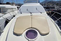 2011 Azimut 55 EVOLUTION yacht with sunpad, docked in a marina.