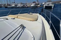 2011 Azimut 55 EVOLUTION yacht docked in marina, featuring spacious sunbathing area.