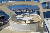 Luxurious 2011 Azimut 55 EVOLUTION yacht with elegant seating in a marina setting.