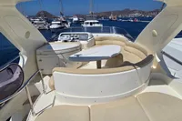 Luxurious 2011 Azimut 55 EVOLUTION yacht deck with seating, table, and scenic marina view.