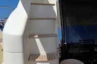 Staircase on 2011 Azimut 55 EVOLUTION yacht, docked in a marina.
