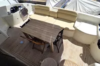 Luxurious 2011 Azimut 55 EVOLUTION yacht deck with seating and wooden table.