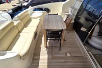 Luxurious 2011 Azimut 55 EVOLUTION yacht deck with seating and dining area.
