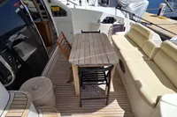 Luxury yacht Azimut 55 EVOLUTION 2011, featuring elegant outdoor seating and wooden table.