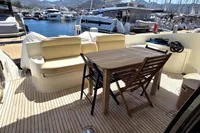 Azimut 55 EVOLUTION 2011 yacht deck with seating and table, docked at marina.
