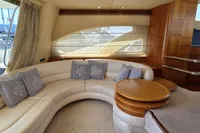 Luxurious interior of 2011 Azimut 55 EVOLUTION yacht with elegant seating and wooden accents.