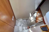 Staircase inside 2011 Azimut 55 EVOLUTION yacht, featuring elegant wood and carpet design.