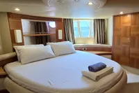 Luxurious bedroom interior of 2011 Azimut 55 EVOLUTION yacht with elegant wood finishes.