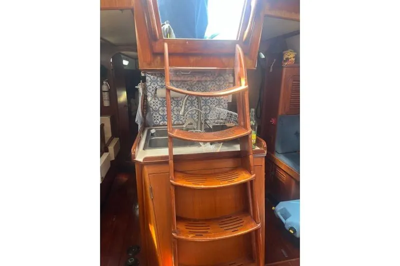 Pickle Yacht Photos Pics Interior of 1989 Hylas 44 sailboat with wooden steps and nautical decor.