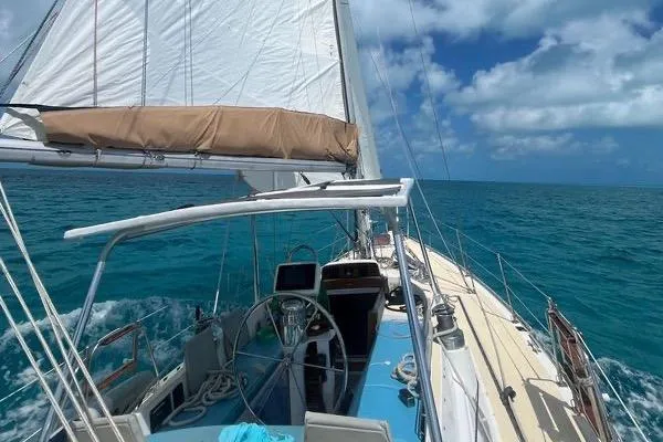 Pickle Yacht Photos Pics 1989 Hylas 44 sailboat navigating clear blue ocean under sunny skies.
