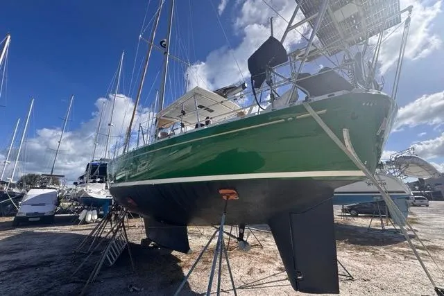Pickle Yacht Photos Pics 1989 Hylas 44 sailboat on dry dock, green hull, clear sky background.