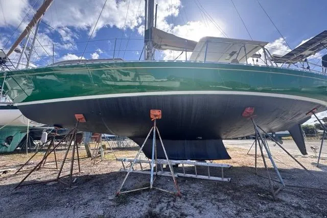 Pickle Yacht Photos Pics 1989 Hylas 44 sailboat on stands, green hull, sunny day, clear sky.