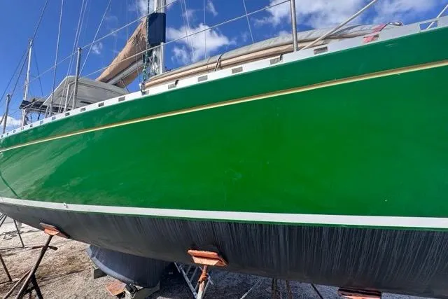 Pickle Yacht Photos Pics 1989 Hylas 44 sailboat with a vibrant green hull on dry dock.