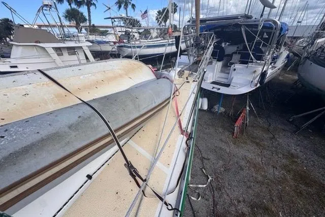 Pickle Yacht Photos Pics 1989 Hylas 44 sailboat on dry dock, surrounded by other boats.
