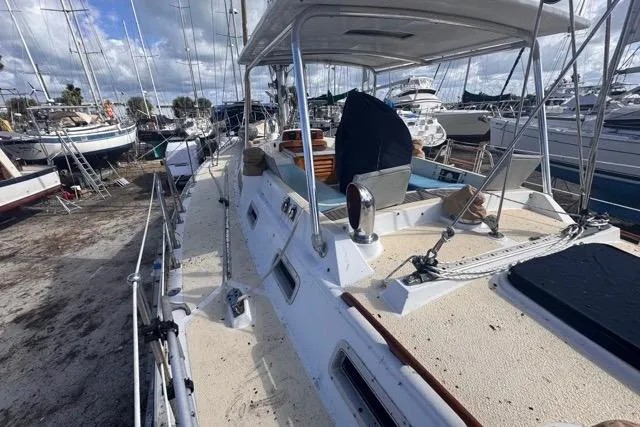 Pickle Yacht Photos Pics 1989 Hylas 44 sailboat on deck, surrounded by other boats in a marina.