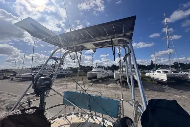Pickle Yacht Photos Pics Sailboat with solar panel, Hylas 44 model, 1989, docked under a blue sky.