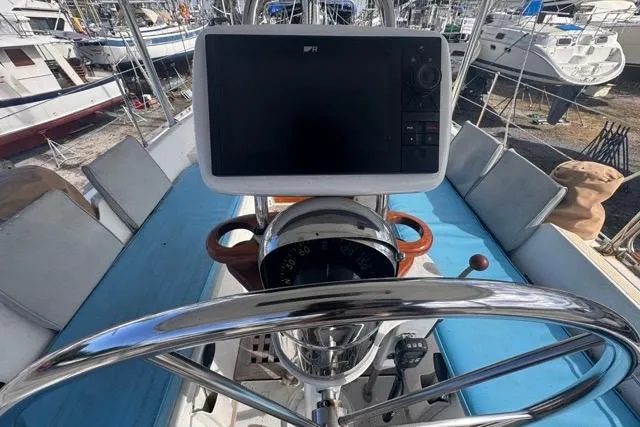 Pickle Yacht Photos Pics Cockpit of 1989 Hylas 44 sailboat with navigation equipment and steering wheel.