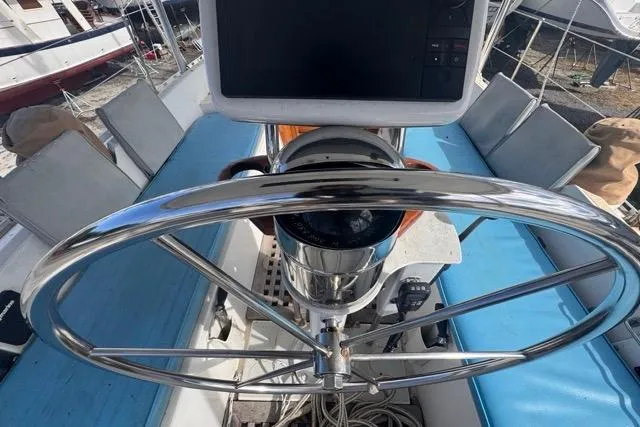 Pickle Yacht Photos Pics Cockpit view of a 1989 Hylas 44 sailboat with a stainless steel steering wheel.