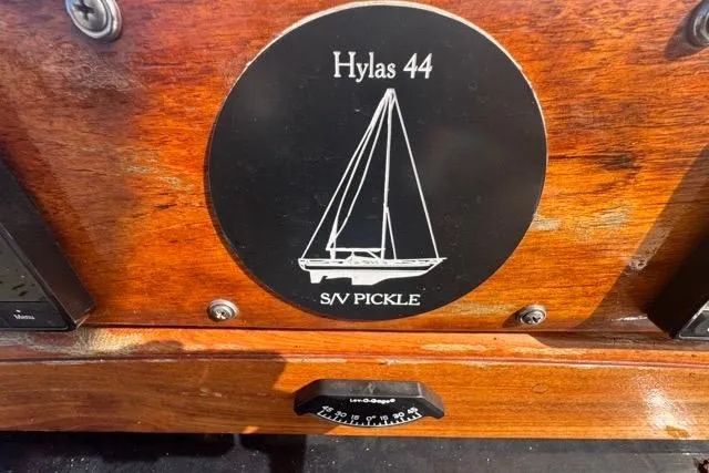 Pickle Yacht Photos Pics Plaque of 1989 Hylas 44 sailboat, S/V Pickle, on wooden surface.