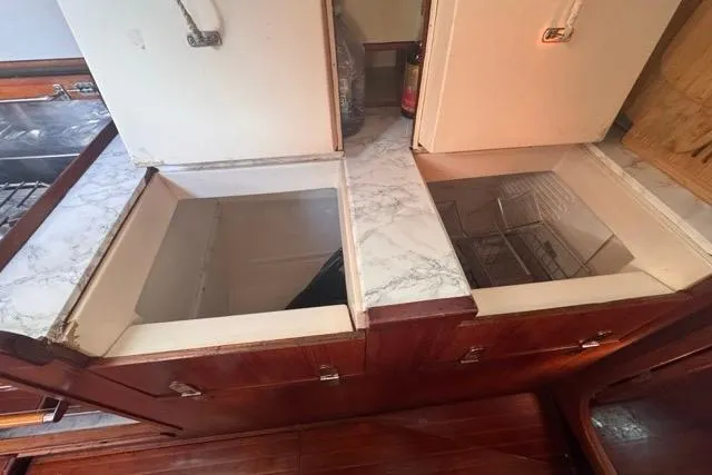 Pickle Yacht Photos Pics Interior of 1989 Hylas 44 yacht showing open storage compartments in the galley.