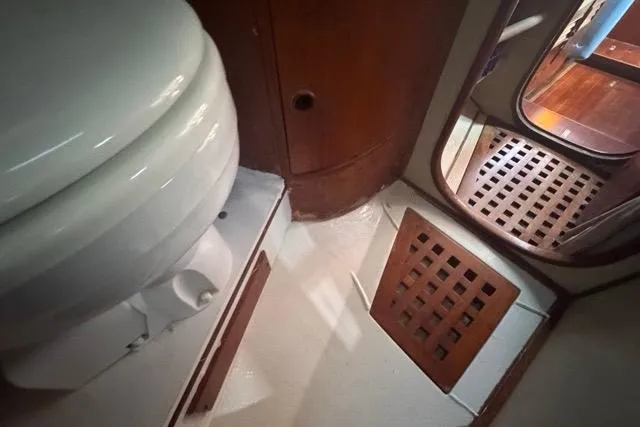 Pickle Yacht Photos Pics Interior of 1989 Hylas 44 yacht bathroom with wooden accents and toilet.