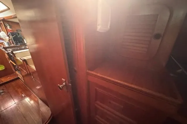 Pickle Yacht Photos Pics Interior of 1989 Hylas 44 sailboat with wooden cabinetry and flooring.