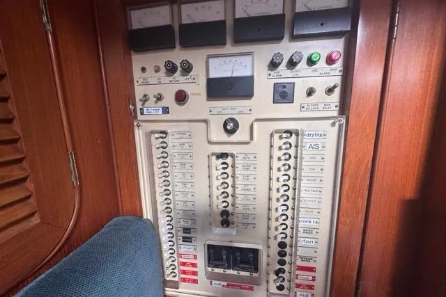 Pickle Yacht Photos Pics Electrical control panel on a 1989 Hylas 44 yacht, featuring switches and gauges.