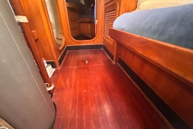 Pickle Yacht Photos Pics Interior of 1989 Hylas 44 sailboat with wooden flooring and cozy cabin space.
