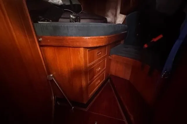 Pickle Yacht Photos Pics Interior of 1989 Hylas 44 sailboat with wooden drawers and seating area.