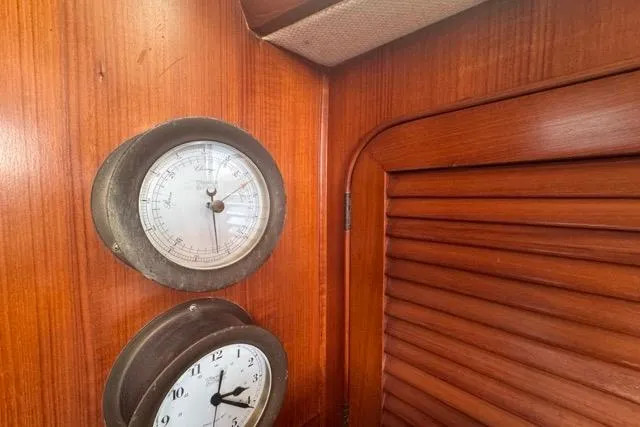 Pickle Yacht Photos Pics Interior of 1989 Hylas 44 yacht with barometer and clock on wooden paneling.