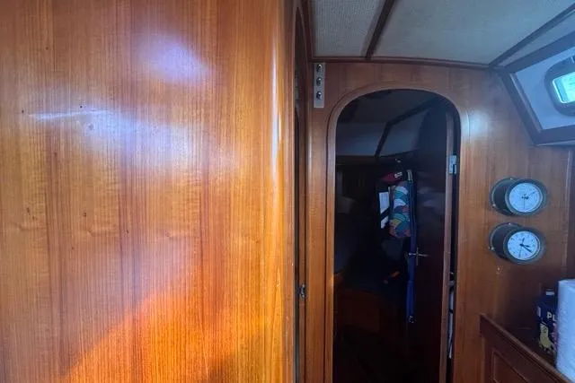 Pickle Yacht Photos Pics Interior of 1989 Hylas 44 sailboat with wooden paneling and nautical instruments.